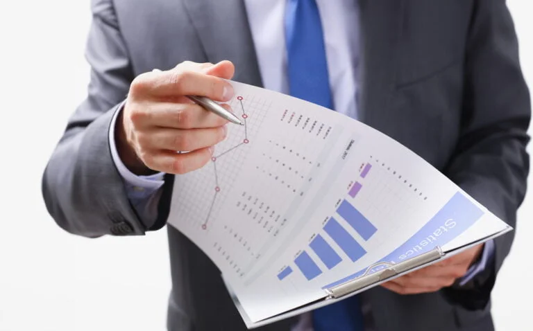 Hand of businessman in suit filling and signing