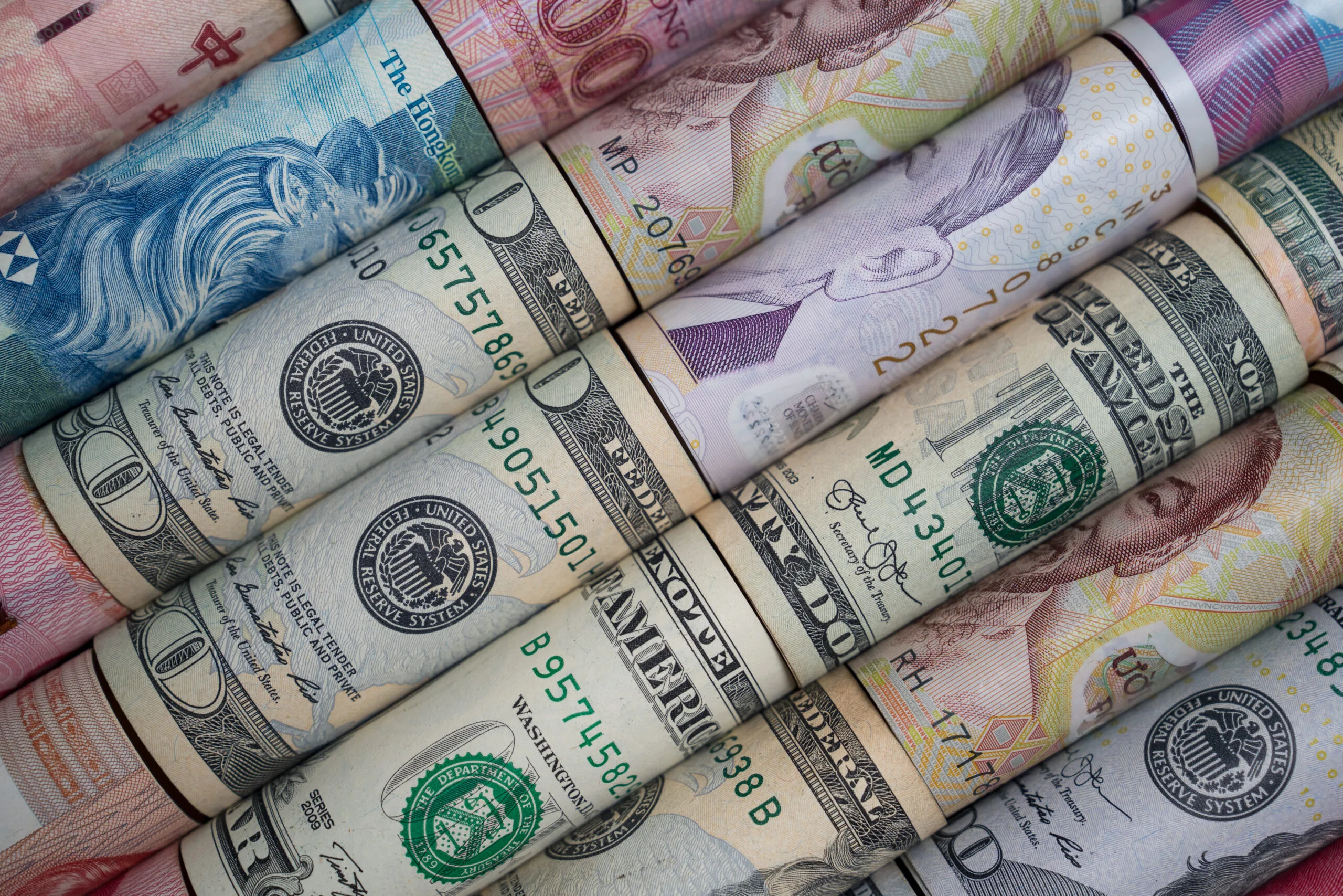 Close up of various international currencies rolled symbolizing global finance money exchange forex investment growth and international economic concepts for business and financial use